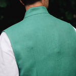 Man wearing a Darzi green vest over a white shirt - focused on back