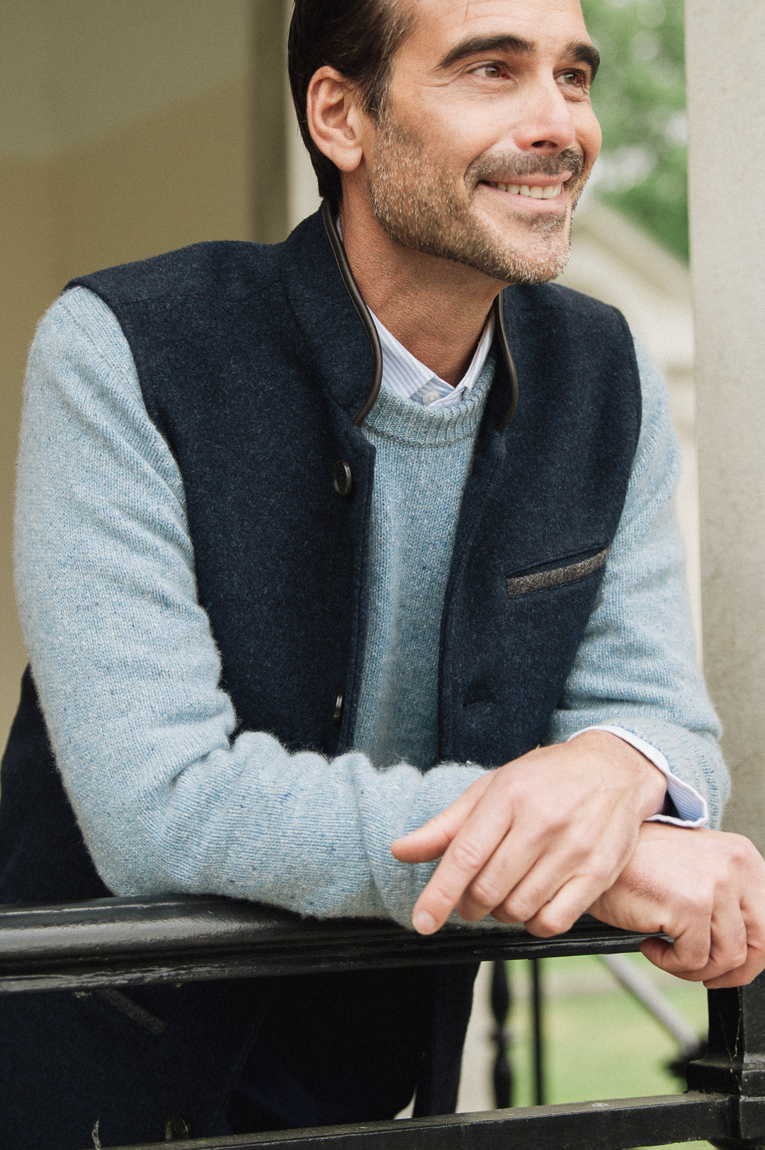 Man wearing a light blue sweater and Darzi Midnight Blue merino wool waistcoat