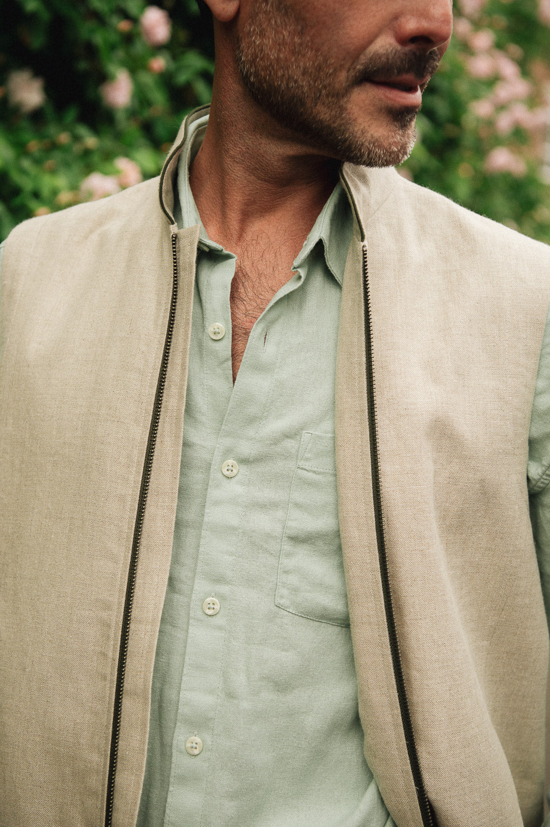 Close up of Darzi limestone linen Hillgate gilet with green trim