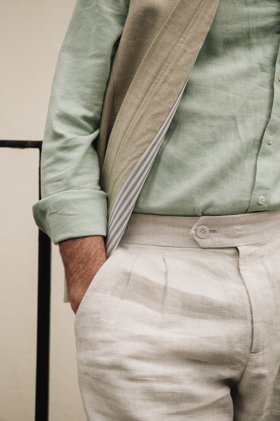 Person wearing a Darzi limestone linen gilet - close-up of cotton lining detail