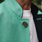 Close-up of a Darzi Como waistcoat in jade green with navy contrast lining