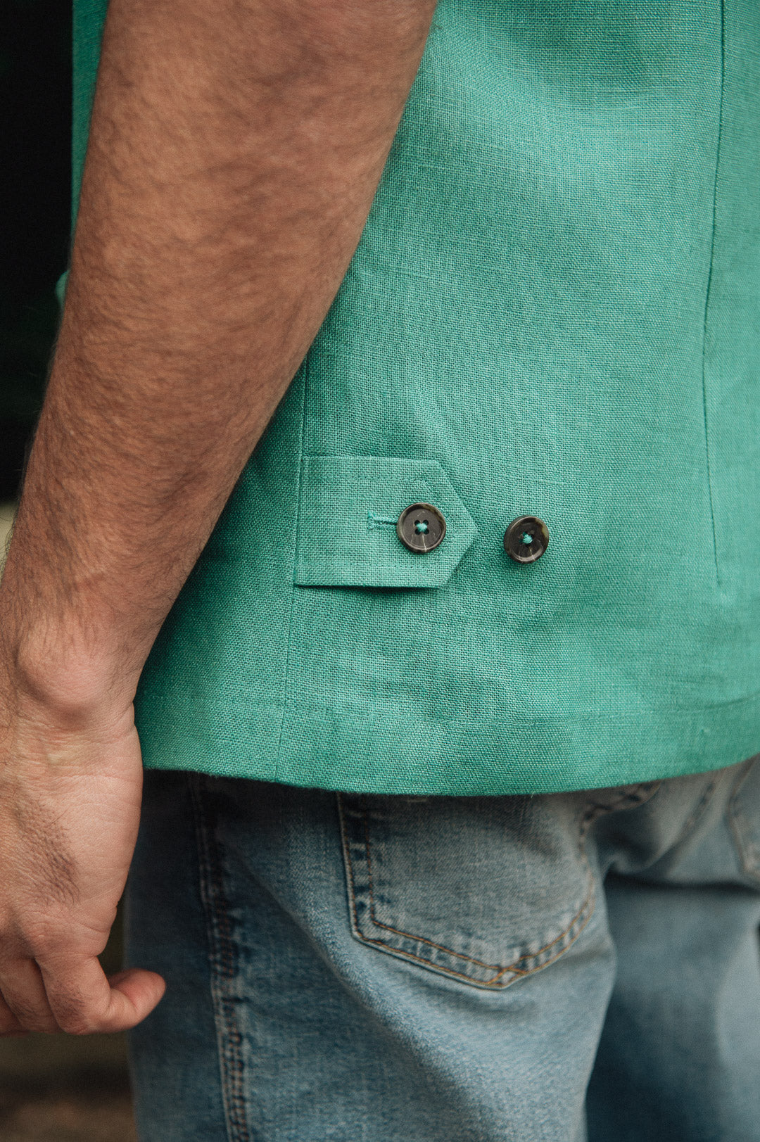 Darzi Como linen waistcoat in Jade Green - focused on side adjusters