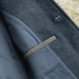 Close-up of a Darzi Midnight Blue merino wool waistcoat - top pocket detail with contrast pocket welt in charcoal grey