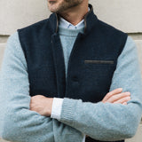 Man wearing a Darzi Midnight Blue merino wool waistcoat over a light blue jumper, set against a neutral background