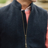 Man wearing a Darzi Hillgate heavyweight midnight blue merino wool gilet over a pink sweater - double brass zip close-up
