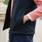 Man wearing a Darzi Hillgate heavyweight midnight blue merino wool gilet over a pink sweater - side pocket close-up