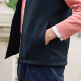 Man wearing a Darzi Hillgate heavyweight midnight blue merino wool gilet over a pink sweater - side pocket close-up