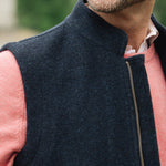 Man wearing a Darzi Hillgate heavyweight midnight blue merino wool gilet over a pink sweater - collar detail