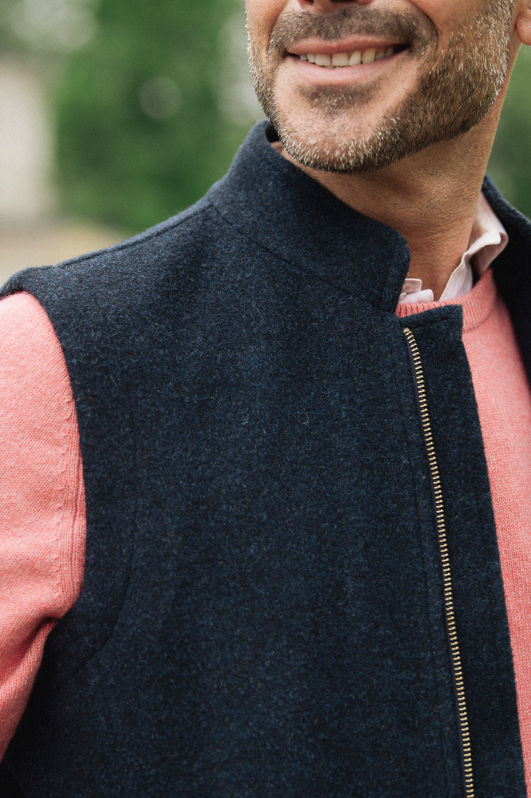 Man wearing a Darzi Hillgate heavyweight midnight blue merino wool gilet over a pink sweater - collar detail