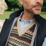 Man wearing a wearing a British made Darzi navy linen Hillgate gilet over a blue shirt in an outdoor setting