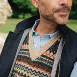 Man wearing a wearing a British made Darzi navy linen Hillgate gilet over a blue shirt in an outdoor setting