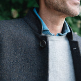 Man wearing a Darzi Helmsley wool waistcoat in Blue Brown Twill over a grey sweater and blue collared shirt - close-up image