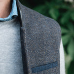 Man wearing a Darzi Helmsley wool waistcoat in Blue Brown Twill over a grey sweater and blue collared shirt