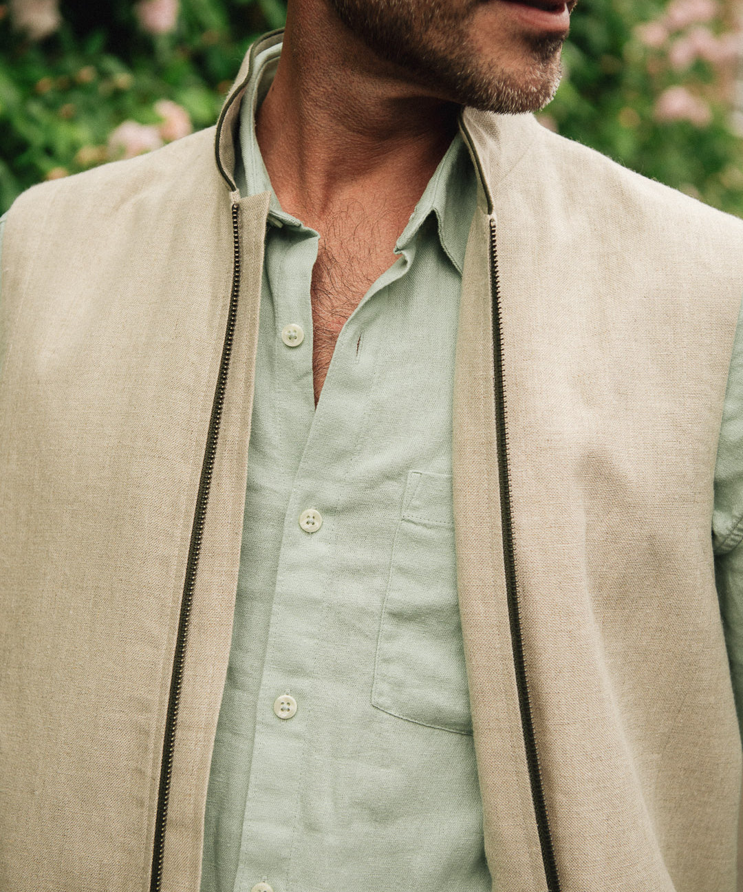 Close up of Darzi limestone linen Hillgate gilet with green trim