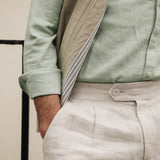 Person wearing a Darzi limestone linen gilet - close-up of cotton lining detail