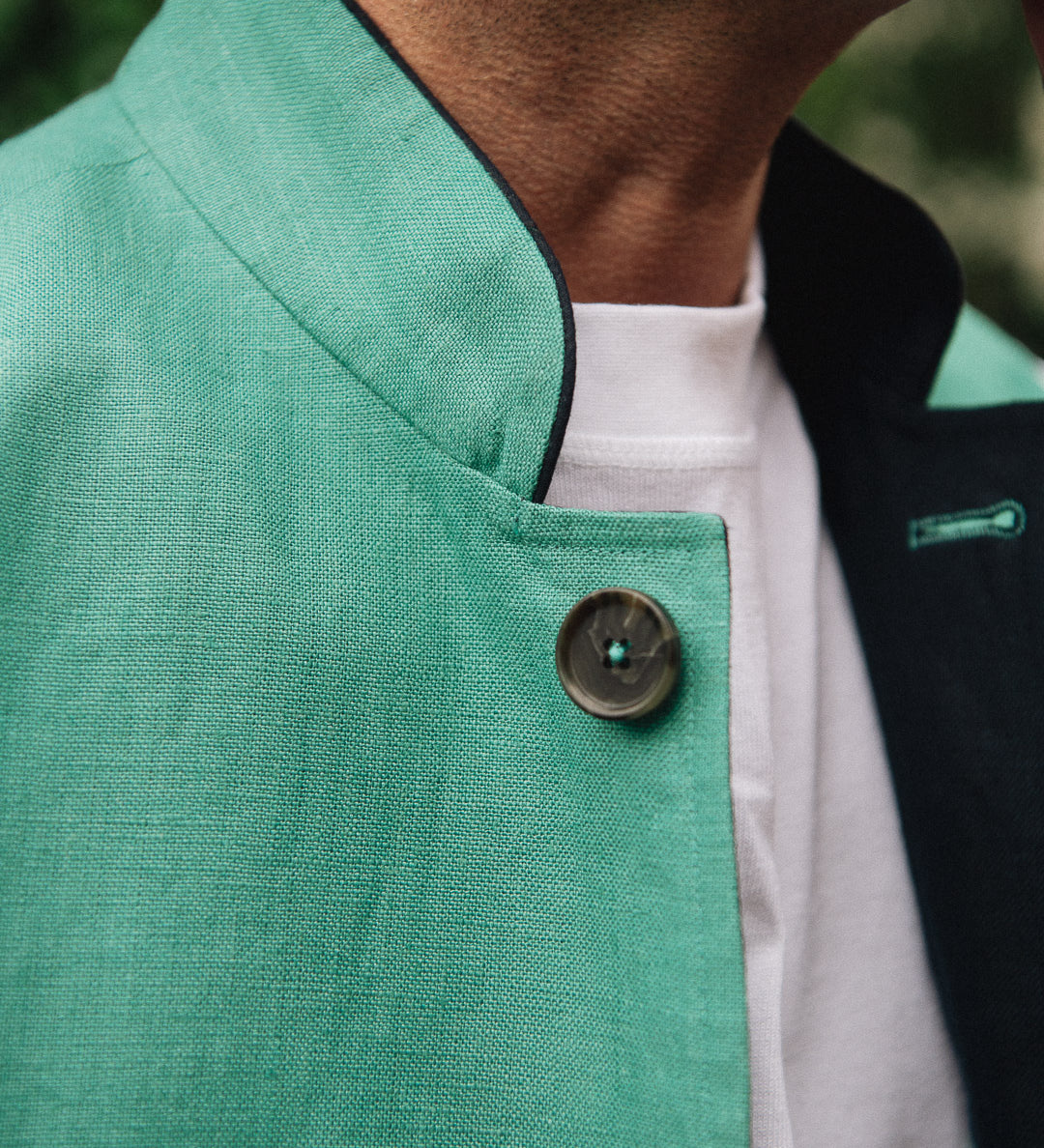 Close-up of a Darzi Como waistcoat in jade green with navy contrast lining