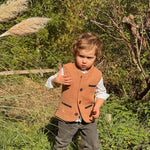 Little boy wearing a Coral Red Little Darzi wool waistcoat