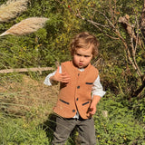 Little boy wearing a Coral Red Little Darzi wool waistcoat