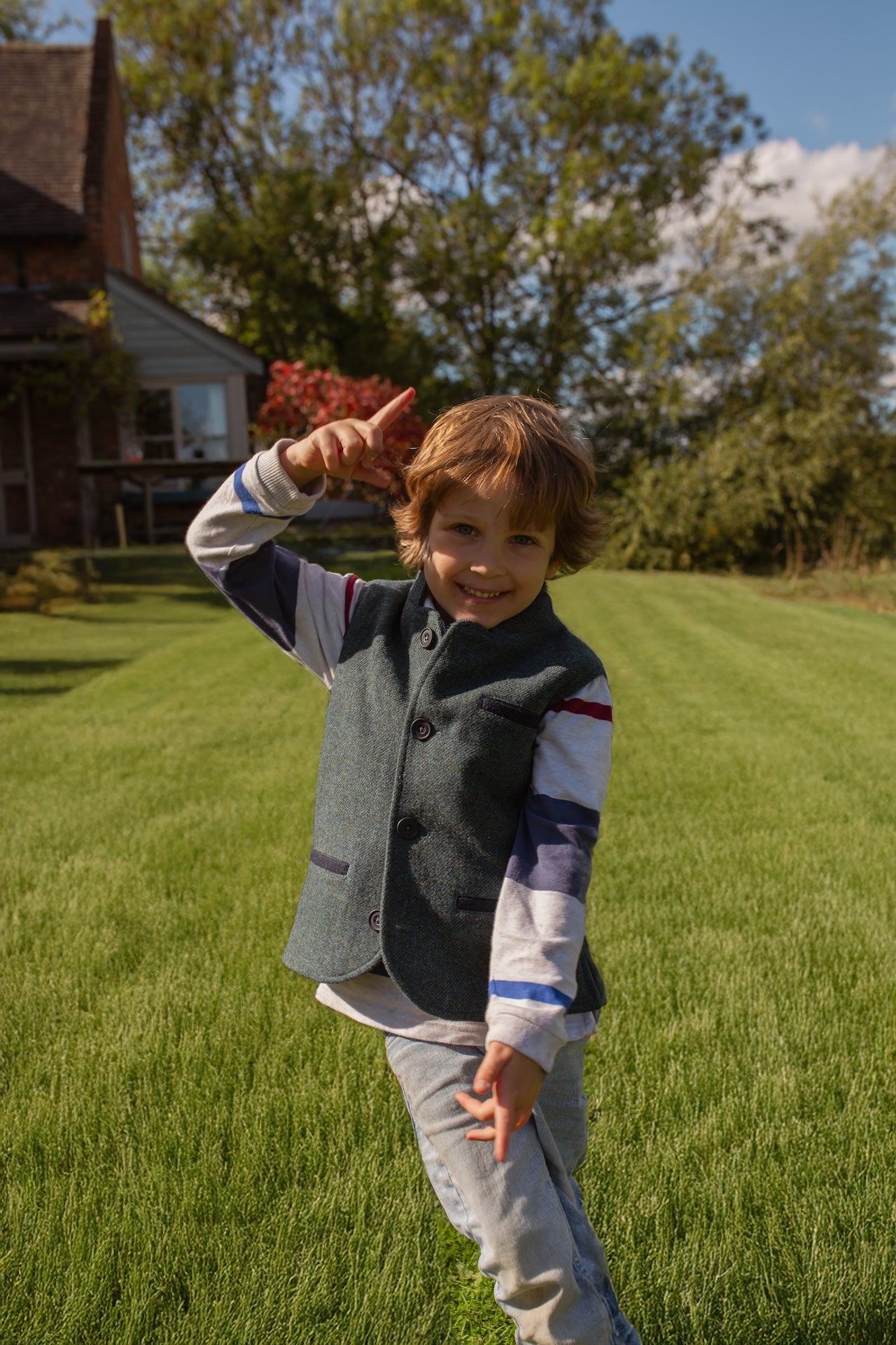 Boy wearing Little Darzi gilet in Deep Teal